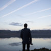 man-with-camera-looking-at-lake large